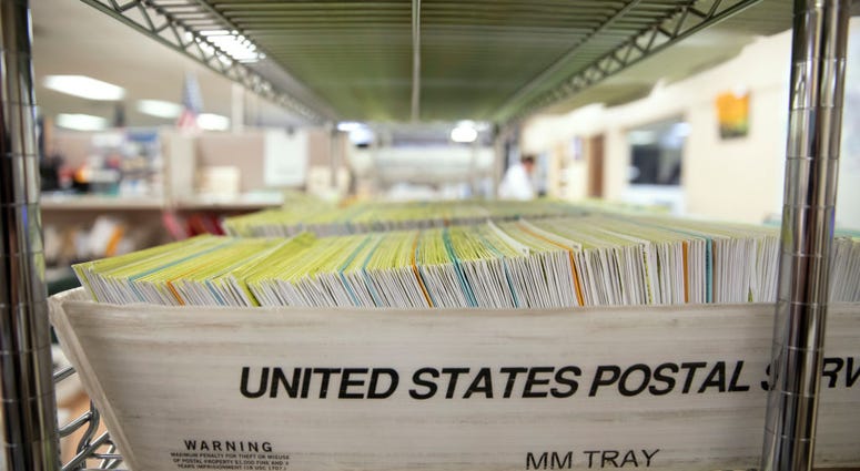Mailed in ballots sit in US Postal Service bins inside the office of the Stanislaus County Clerk on November 6, 2018 in Modesto, California.
