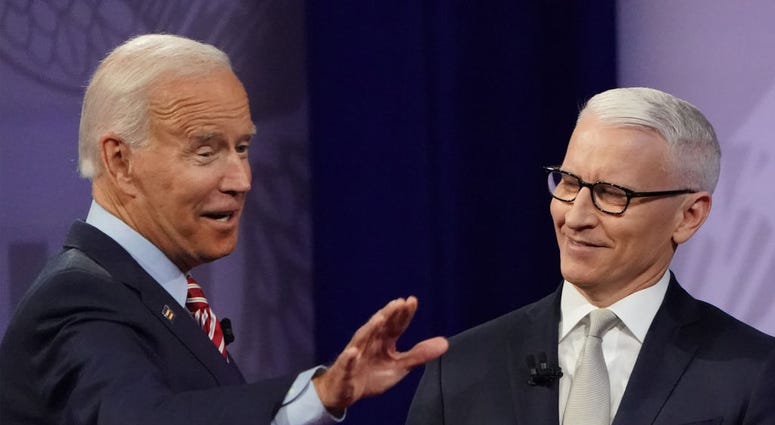 Democratic U.S. presidential candidate and former Vice President Joe Biden (L) gestures with CNN moderator Anderson Cooper at the Human Rights Campaign Foundation and CNN’s presidential town hall, focused on LGBTQ issues, on October 10, 2019 in LA