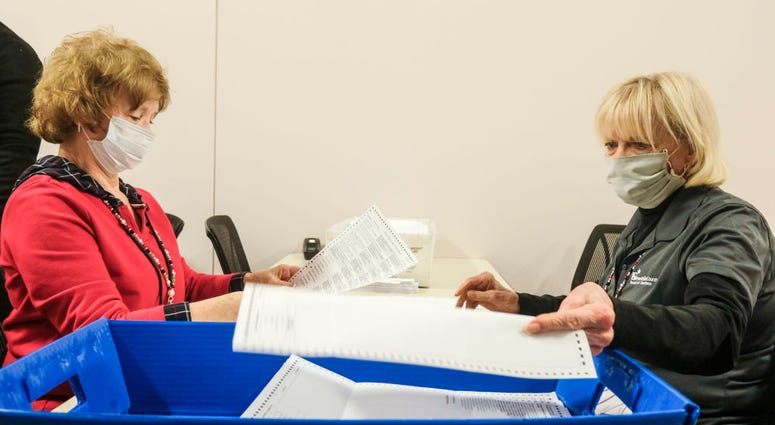 Employees and volunteers of the Franklin County Board of Elections sort through, and de-stub both mail in ballots and provisional ballots on April 28, 2020 in Columbus, Ohio