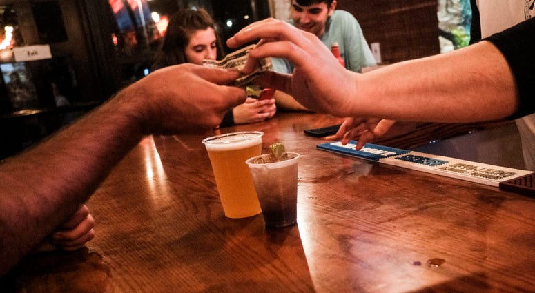 COLUMBUS, OH - JULY 31: Customers enjoy a last round of drinks at a bar in the Short North District on July 31, 2020 in Columbus, Ohio.