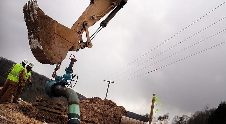 Men with Cabot Oil and Gas work on a natural gas valve at a hydraulic fracturing site on January 18, 2012 in South Montrose, Pennsylvania.