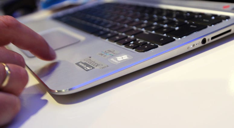 A visitor tries out an HP Spectre XT laptop computer featuring an Intel Ultrabook processor at the Internationale Funkausstellung (IFA) 2012 consumer electronics trade fai