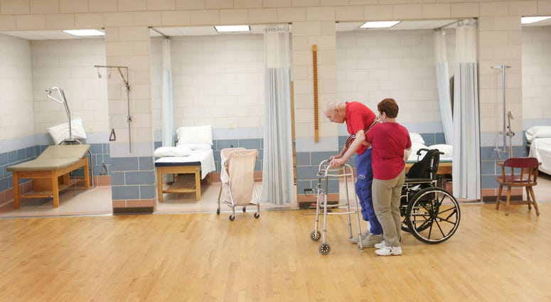 Shirley Gooding, a physical Therapy Aid, helps William Rexroat, a WWII Navy veteran exercise during a physical therapy session at the Quincy Veterans Home February 17, 2005 in Quincy, Illinois