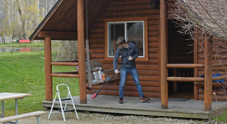 April 28, 2020; Erie, PA, USA;Spencer Conaway, 19, cleans a cabin, April 28, 2020, at the KOA campground in McKean Township. Crews at area campgrounds, marinas and golf course are busy preparing to open Friday