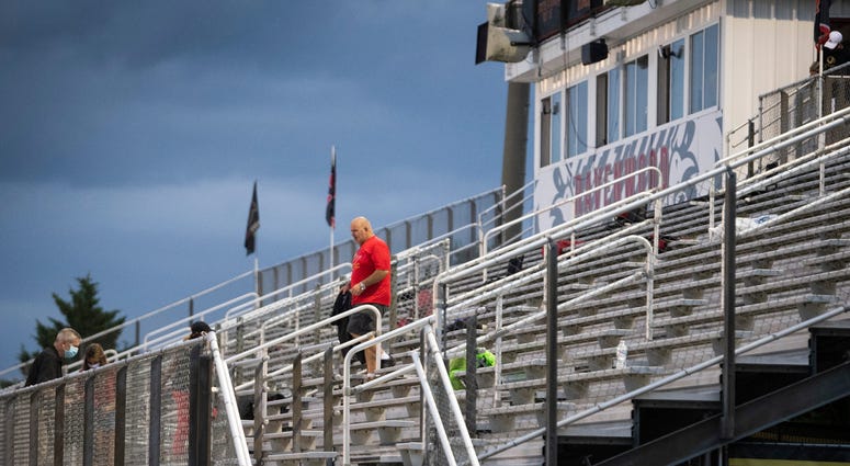 A Ravenwood fan leaves the stadium before their game against Blackman during a weather delay at Ravenwood High School Thursday, Aug. 27, 2020 Nashville, Tenn.