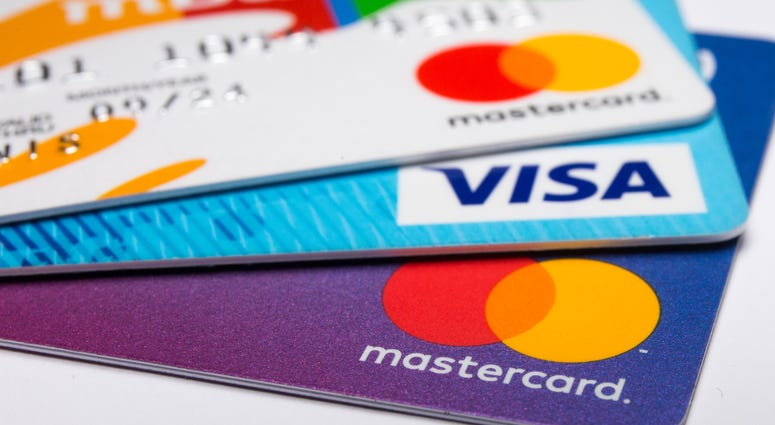 n this photo illustration a Visa credit card and Mastercard debit cards are seen displayed.
