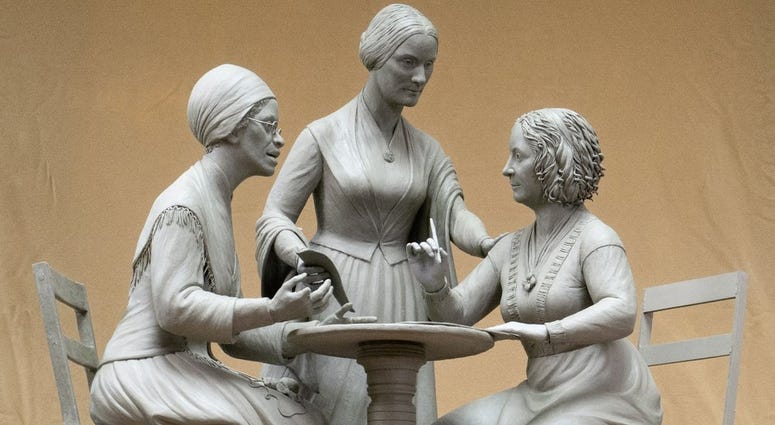 This Oct. 6, 2019 photo provided by Michael Bergmann shows a one-third scale clay model of Sojourner Truth, left, Susan B. Anthony, center, and Elizabeth Cady Stanton at Meredith Bergmann's studio in Ridgefield, Conn