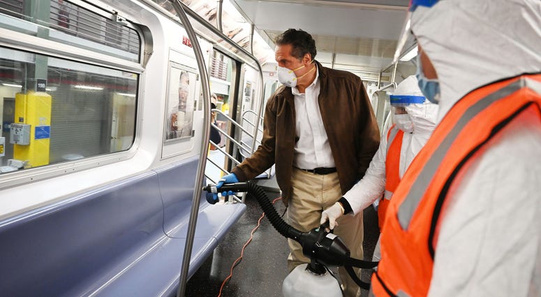 Cuomo disinfects a 7 train car in Queens. Cuomo disinfects a 7 train car in Queens
