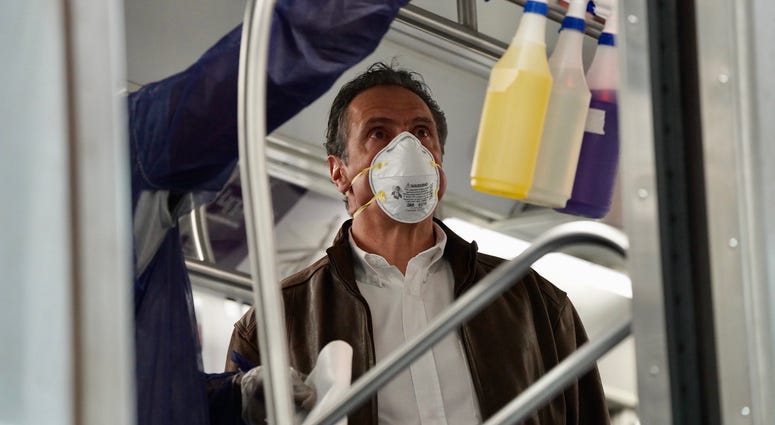 Cuomo disinfects a 7 train car in Queens. Cuomo disinfects a 7 train car in Queens