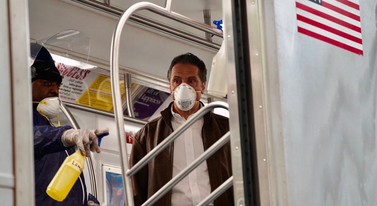 Cuomo disinfects a 7 train car in Queens. Cuomo disinfects a 7 train car in Queens