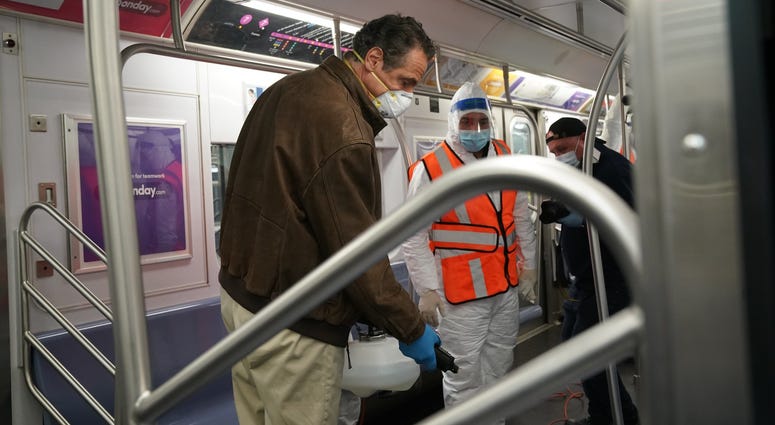 Cuomo disinfects a 7 train car in Queens. Cuomo disinfects a 7 train car in Queens