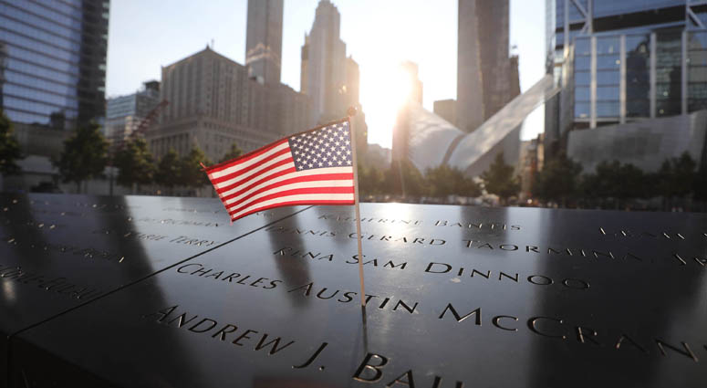 A flag placed on a panel on the north pool with names of those lost on September 11, 2001 in the World Trade Center. 9/11 Memorial