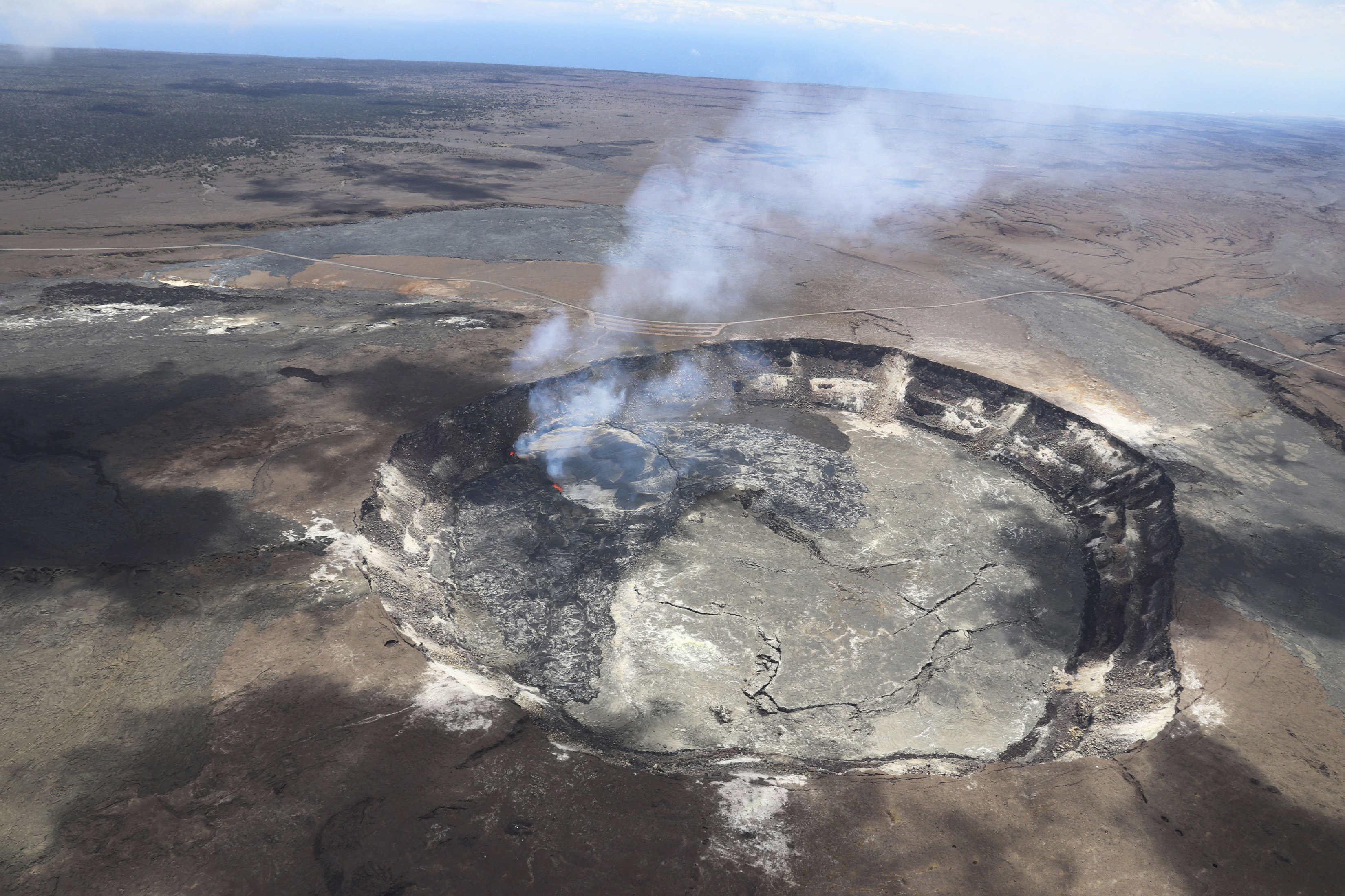 This April 23, 2018 photo provided by the U.S. Geological Survey shows the extent of the large overflow of a lava lake in Kilauea Volcano in Hawaii Volcanoes National Park on Hawaii's Big Island This April 23, 2018 photo provided by the U.S. Geological Survey shows the extent of the large overflow of a lava lake in Kilauea Volcano in Hawaii Volcanoes National Park on Hawaii's Big Island