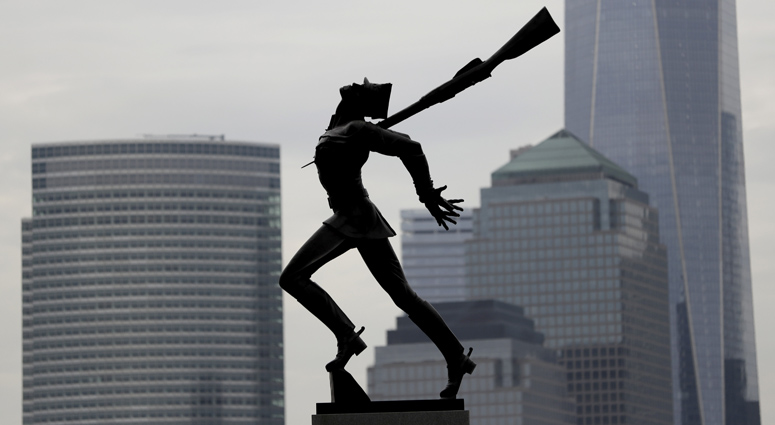 Buildings in Lower Manhattan provide a backdrop to a statue dedicated to the victims of the Katyn massacre of 1940, Friday, May 4, 2018, in Jersey City, N.J. Jersey City Katyn Statue