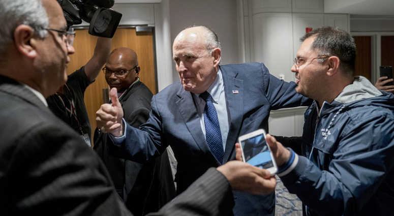 Rudy Giuliani, center, an attorney for U.S. President Donald Trump, leaves after speaking at the Iran Freedom Convention for Human Rights and democracy at the Grand Hyatt, Saturday, May 5, 2018, in Washington. Rudy Giuliani