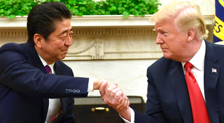President Donald Trump shakes hands with Japanese Prime Minister Shinzo Abe