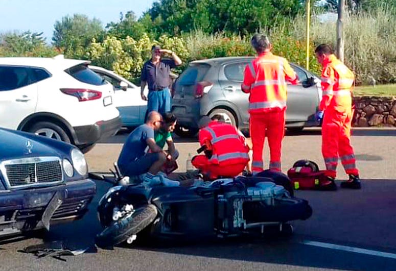 Ambulance personnel tend to a man lying on the ground, later identified as actor George Clooney, after being involved in a scooter accident in the near Olbia, on the Sardinia island, Italy, Tuesday, July 10, 2018.