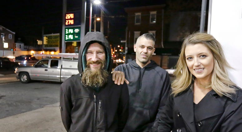 In this Nov. 17, 2017, file photo, Johnny Bobbitt Jr., left, Kate McClure, right, and McClure's boyfriend Mark D'Amico pose at a Citgo station in Philadelphia. In this Nov. 17, 2017, file photo, Johnny Bobbitt Jr., left, Kate McClure, right, and McClure's boyfriend Mark D'Amico pose at a Citgo station in Philadelphia.