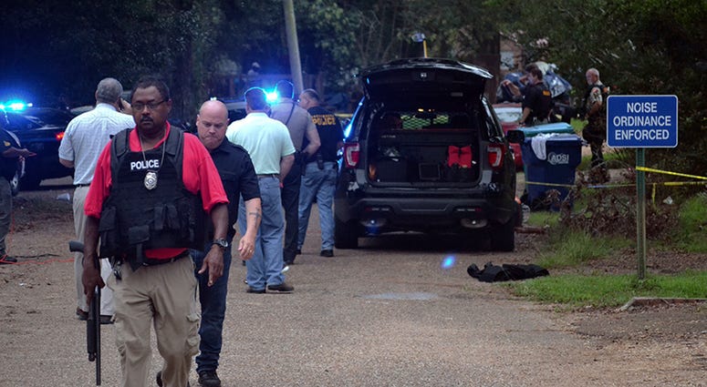 Law enforcement agents secure the scene of a shooting in Brookhaven, Miss., where two police officers were killed Saturday morning, Sept. 29, 2018. Mississippi Cop Shooting