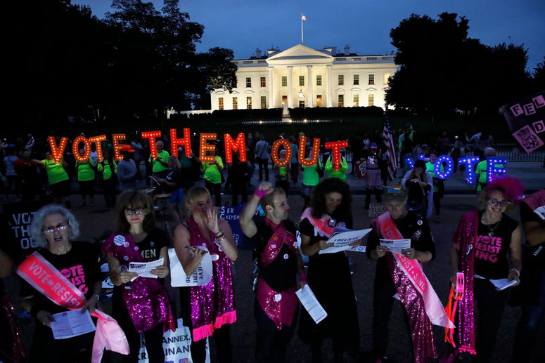 As dusk falls, groups including "Sing Out Louise," of New York City, protest the confirmation of Brett Kavanaugh to the Supreme Court. Protests White House