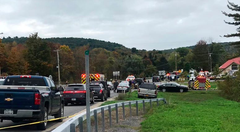 In this Saturday, Oct. 6, 2018 photo, emergency personnel respond to the scene of a deadly crash in Schoharie, N.Y. Limo Crash