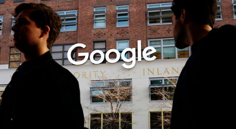 People walk by Google in NYC