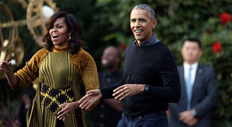 FILE - In this Oct. 31, 2016 file photo, President Barack Obama and the first lady Michelle Obama dance with kids to the beat of "Thriller" during a Halloween celebration at the South Portico of the White House in Washington. Barack and Michelle Obama