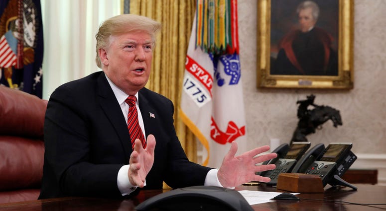 President Donald Trump greets members of the five branches of the military by video conference on Christmas Day, Tuesday, Dec. 25, 2018, in the Oval Office of the White House Trump Oval Office