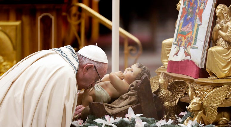 Pope Francis kisses a statue of Baby Jesus as he celebrates a new year's eve vespers Mass in St. Peter's Basilica at the Vatican, Monday, Dec. 31, 2018. New Year Vatican