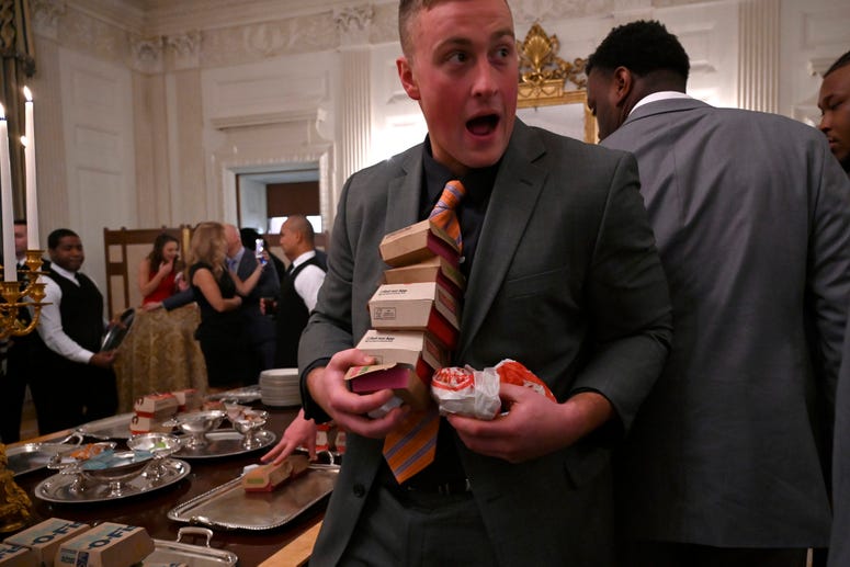 Guests attending a reception for the Clemson Tigers grab fast food sandwiches in the State Dining Room of the White House in Washington, Monday, Jan. 14, 2019. Trump McDonalds
