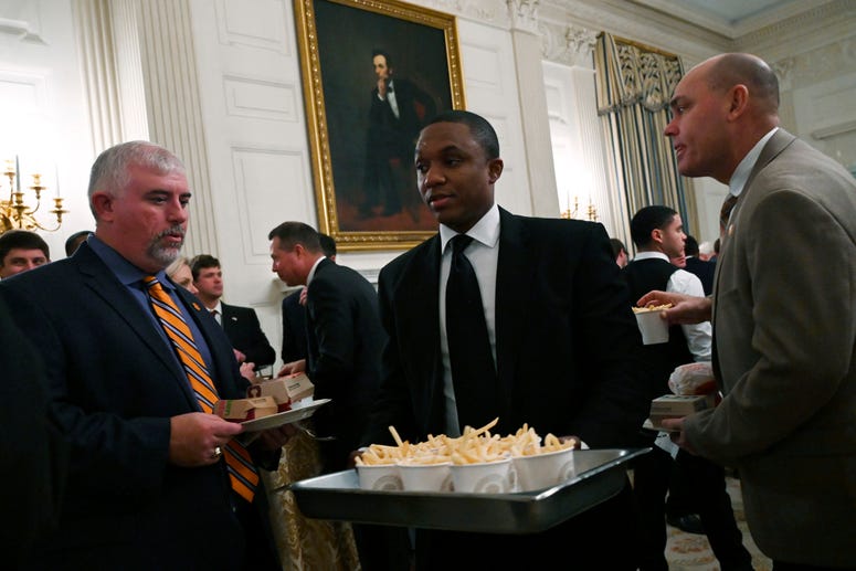 Guests attending a reception for the Clemson Tigers watch as more French fries are brought out to the State Dining Room of the White House in Washington, Monday, Jan. 14, 2019. Trump McDonalds