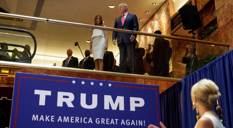 In this Sunday, June 16, 2015, file photo, Donald Trump, accompanied by his wife Melania Trump, is applauded by his daughter Ivanka Trump, right as he's introduced before his announcement that he will run for president in the lobby of Trump Tower. Trump Tower