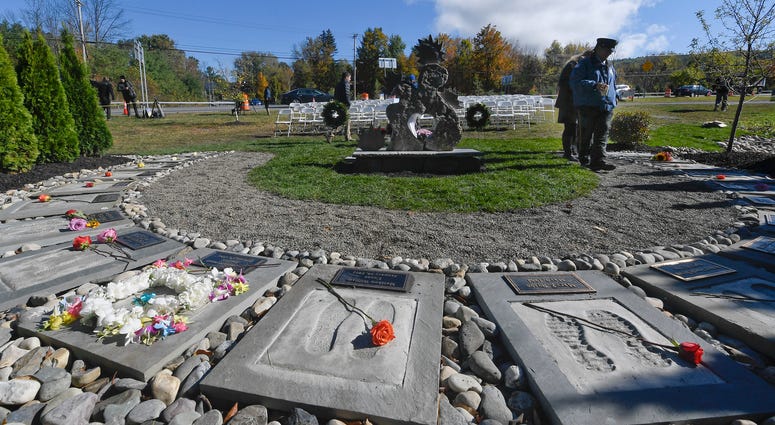 First responders look over the Reflections Memorial after a unveiling ceremony, on the one year anniversary of the Schoharie limousine crash that killed 20 people next to the Apple Barrel Restaurant Saturday, Oct. 5, 2019, in Schoharie, N.Y. Schoharie