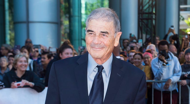 In this Sept. 12, 2018 file photo, actor Robert Forster poses for photographs on the red carpet for the new movie "What They Had" during the 2018 Toronto International Film Festival in Toronto. Robert Forster