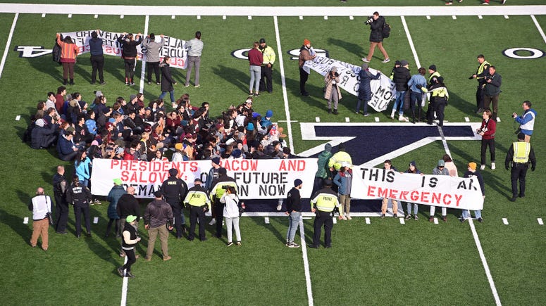Demonstrators stage a climate change protest at the Yale Bowl delaying the start of the second half of an NCAA college football game between Harvard and Yale Saturday, Nov. 23, 2019, in in New Haven, Conn. Protest