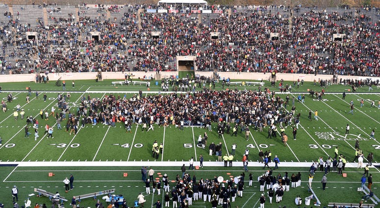 Demonstrators stage a climate change protest at the Yale Bowl delaying the start of the second half of an NCAA college football game between Harvard and Yale Saturday, Nov. 23, 2019, in in New Haven, Conn. Climate protest