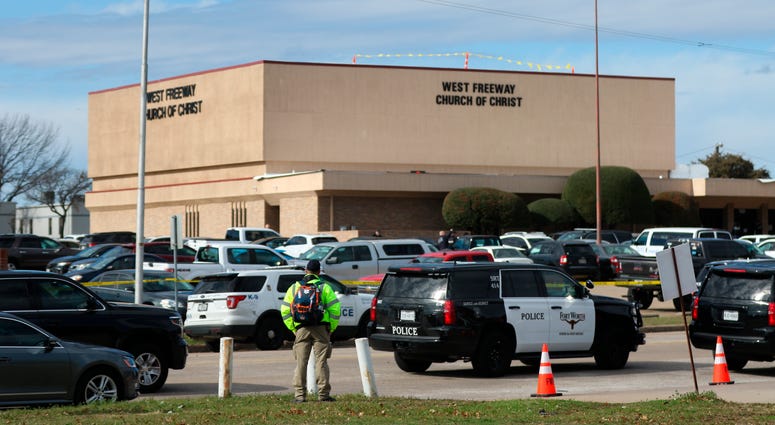 A person stands near the scene of a church shooting at West Freeway Church of Christ on Sunday, Dec. 29, 2019 in White Settlement, Texas. Texas church shooting