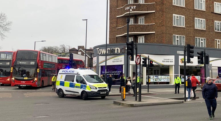 Police attend the scene after an incident in Streatham, London, Sunday Feb. 2, 2020. London police say officers shot a man during a “terrorism-related incident” that involved the stabbings of “a number of people.” London stabbing