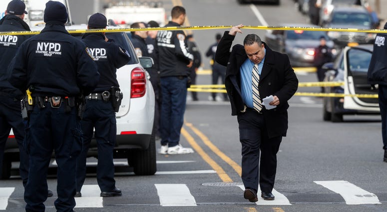 New York City police officers work the scene of a police involved shooting outside the 41st precinct Sunday, Feb. 9, 2020, in New York. NYPD officers shot