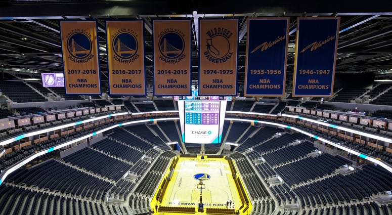In this Aug. 26, 2019, file photo, the Golden State Warriors championship banners hang above the seating and basketball court at the Chase Center in San Francisco. The Warriors will play the Brooklyn Nets at home Thursday night, March 12, 2020 In this Aug. 26, 2019, file photo, the Golden State Warriors championship banners hang above the seating and basketball court at the Chase Center in San Francisco. The Warriors will play the Brooklyn Nets at home Thursday night, March 12, 2020