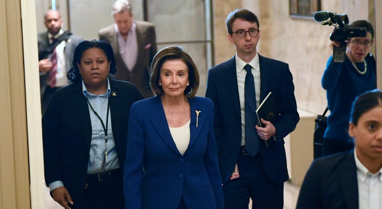 In this Friday, March 27, 2020 file photo, House Speaker Nancy Pelosi, D-Calif., arrives on Capitol Hill in Washington. In this Friday, March 27, 2020 file photo, House Speaker Nancy Pelosi, D-Calif., arrives on Capitol Hill in Washington.