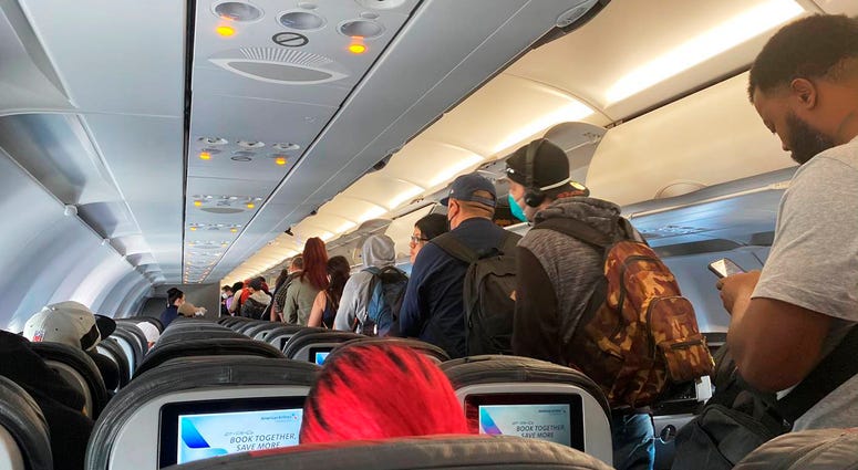 FILE - In this Monday, April 27, 2020, file photo, provided by Vince Warburton, passengers get off an American Airlines flight after they landed at Los Angeles International Airport in Los Angeles. FILE - In this Monday, April 27, 2020, file photo, provided by Vince Warburton, passengers get off an American Airlines flight after they landed at Los Angeles International Airport in Los Angeles.