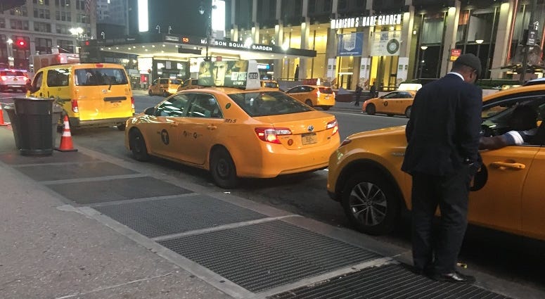 Yellow taxis outside Penn Station Yellow Taxis
