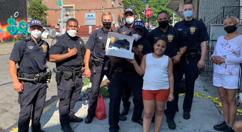 NYPD officers helped with 10-year-old Juliette a happy birthday. NYPD officers with girl a happy birthday