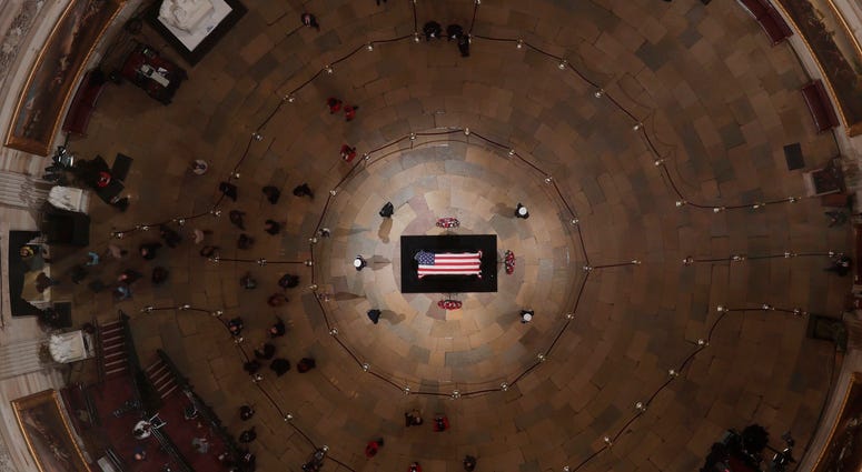 The last of the public files out of the Rotunda as the casket of the late former President George H.W. Bush lies in state in the Capitol Rotunda on December 5, 2018 in Washington, DC. George H.W. Bush