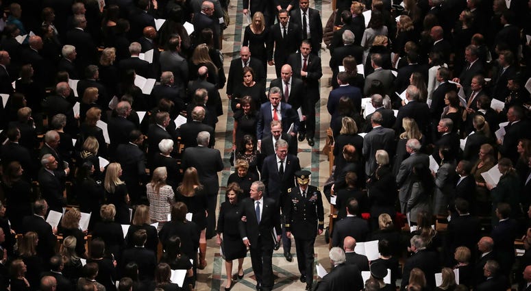 Members former President George H.W. Bush's family, including former President George W. Bush, Laura Bush, former Florida Governor Jeb Bush and Columba Bush, follow his casket out of the National Cathedral at the conclusion of his state funeral December 0 George H.W. Bush