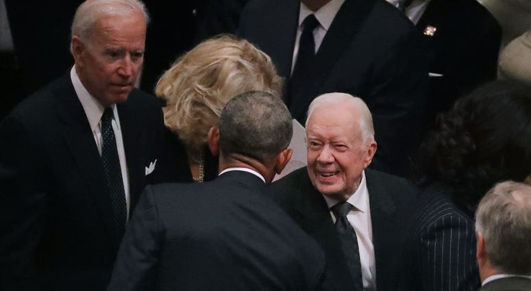 Former presidents Barack Obama and Jimmy Carter greet one another during the state funeral for former President George H.W. Bush at the National Cathedral December 05, 2018 in Washington, DC. George H.W. Bush