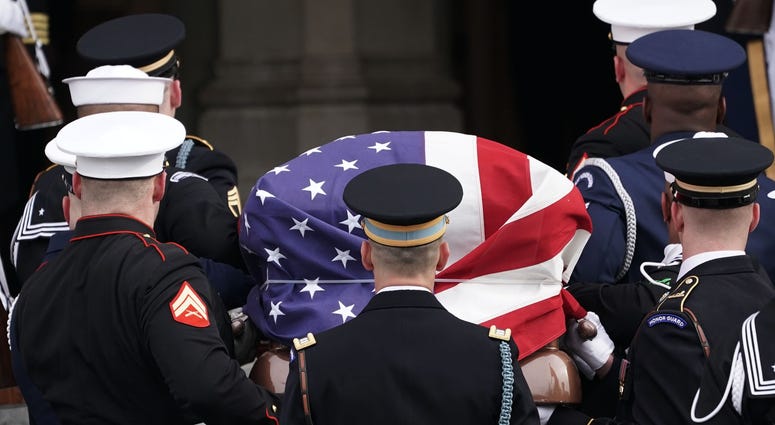 A joint service honor guard carries the casket of former US President George H.W. Bush into the Washington National Cathedral on December 5, 2018 in Washington, DC. George H.W. Bush