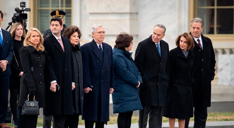 : (L-R) Janna Ryan, Speaker of the House Paul Ryan, Transportation Secretary Elaine Chao, Senate Majority Leader Mitch McConnell, Iris Weinshall, Senate Minority Leader Chuck Schumer, House Minority Leader Nancy Pelosi and Paul Pelosi await the casket. George H.W. Bush