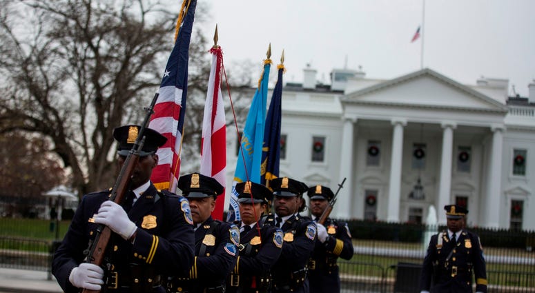 Honor Guard members depart after a hearse carrying the remains of former U.S. President George H.W. Bush passed the White House en route to the National Cathedral before a state funeral on December 5, 2018 in Washington, DC. George H.W. Bush